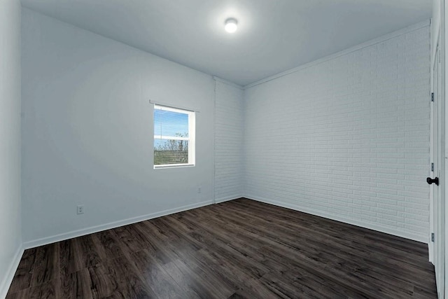 unfurnished room featuring dark wood-style flooring and baseboards