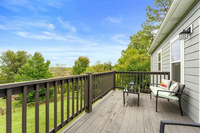 wooden terrace featuring a yard