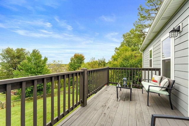 wooden deck featuring a yard