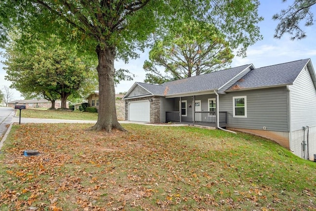 ranch-style house with an attached garage, covered porch, and a front lawn