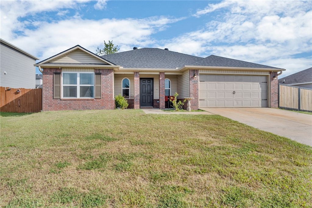 ranch-style home with a garage and a front lawn