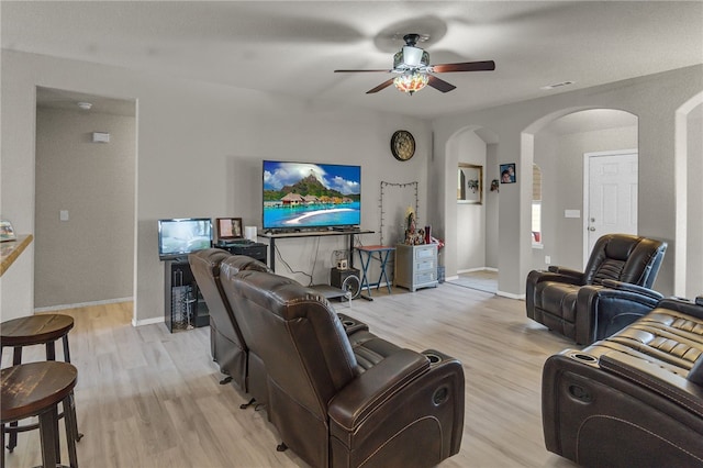 living room featuring light hardwood / wood-style floors and ceiling fan