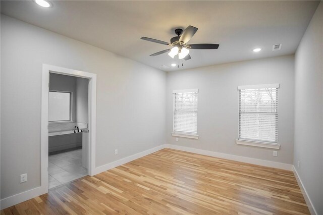 unfurnished room with light wood-type flooring and ceiling fan