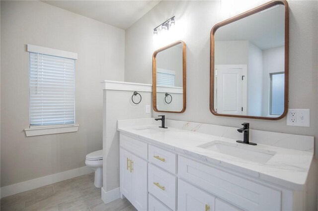 bathroom featuring tile patterned flooring, vanity, and toilet