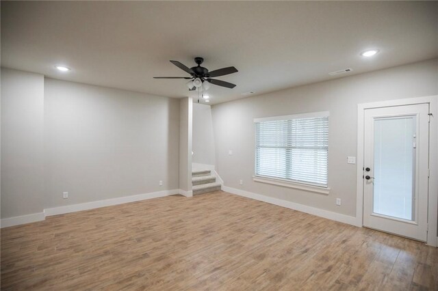 unfurnished living room with ceiling fan and light hardwood / wood-style flooring