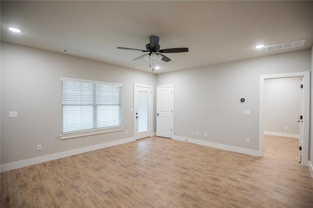 empty room featuring ceiling fan and light wood-type flooring