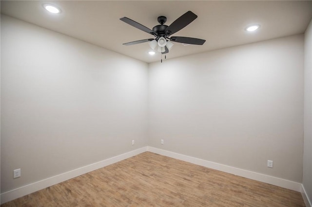 empty room featuring hardwood / wood-style flooring and ceiling fan