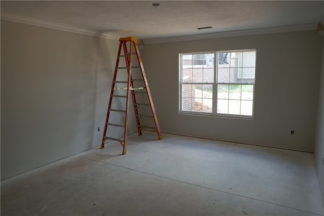 empty room featuring ornamental molding and concrete flooring