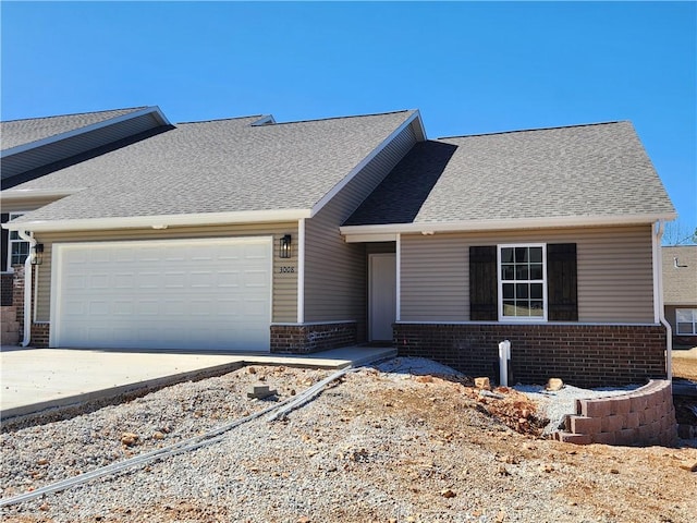 view of front of home with driveway, an attached garage, roof with shingles, and brick siding