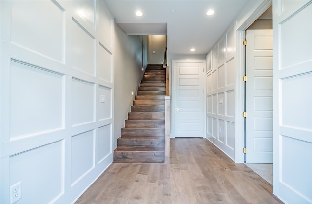 stairs with hardwood / wood-style floors