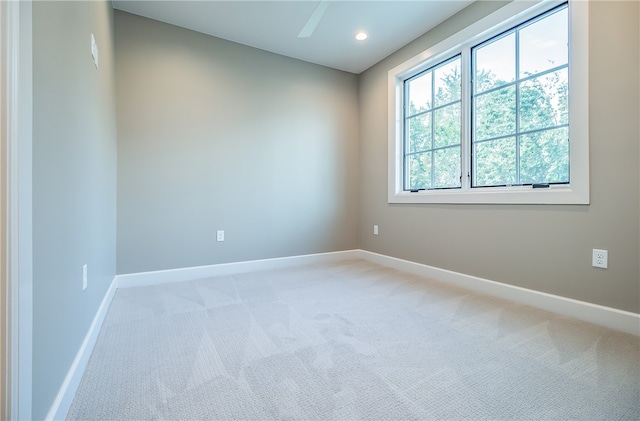 unfurnished room with carpet and ceiling fan