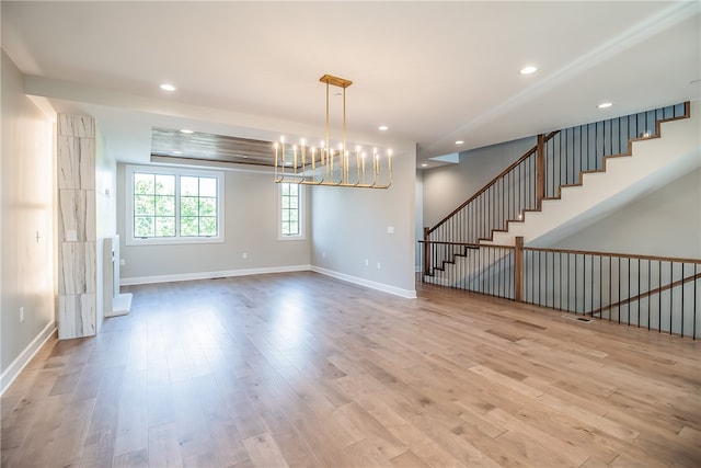 interior space featuring an inviting chandelier and light hardwood / wood-style floors