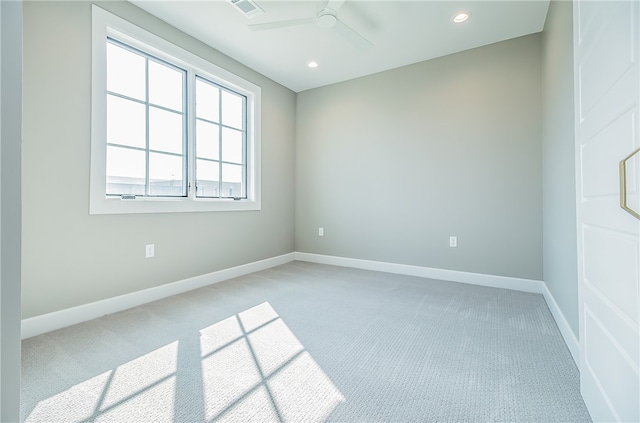 carpeted spare room with ceiling fan