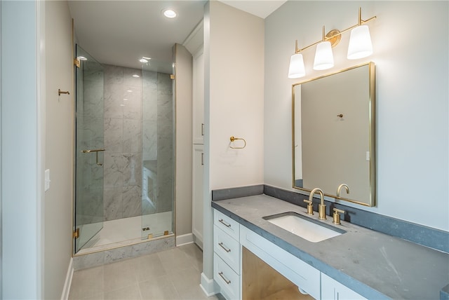 bathroom with tile patterned flooring, walk in shower, and vanity