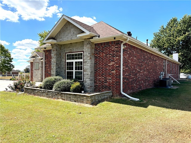 view of property exterior featuring a yard and central AC unit