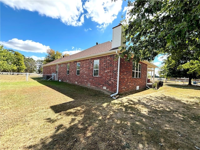 view of side of property with a yard