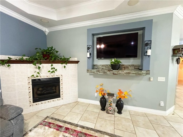 8825 Sky Watch Ln, Decatur, AR 72722 - living area featuring a tray ceiling, crown molding, a tiled fireplace, tile patterned flooring, and baseboards