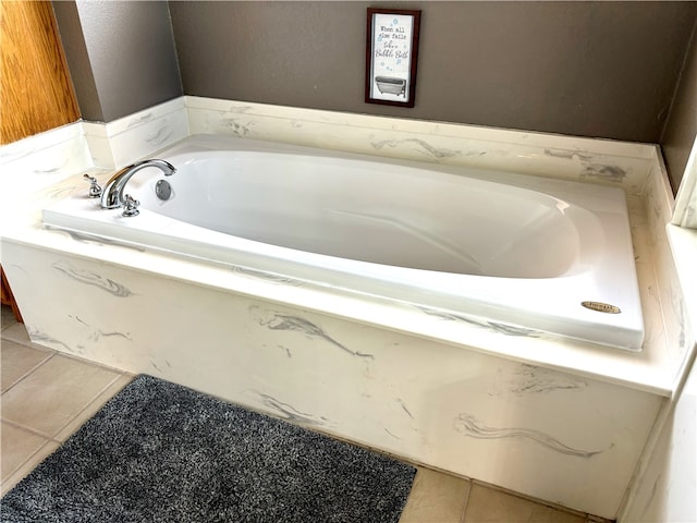 bathroom with a bath and tile patterned floors