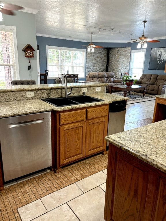 kitchen featuring dishwasher, a textured ceiling, sink, light tile patterned floors, and ceiling fan