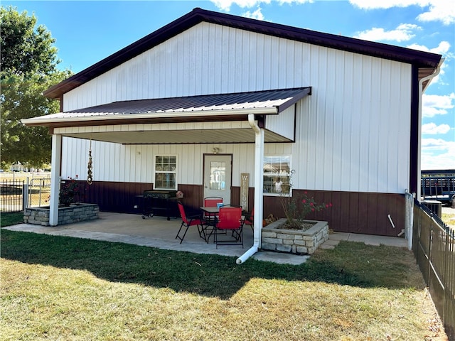 back of property featuring a yard and a patio area