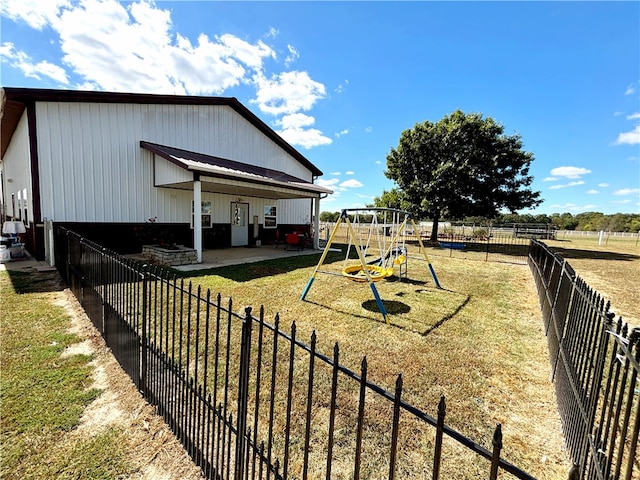 view of yard featuring a playground and a patio area