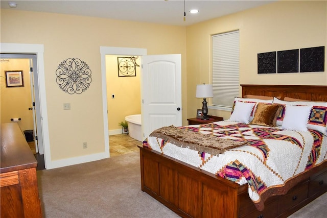 carpeted bedroom with connected bathroom