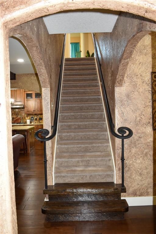 stairs with hardwood / wood-style floors