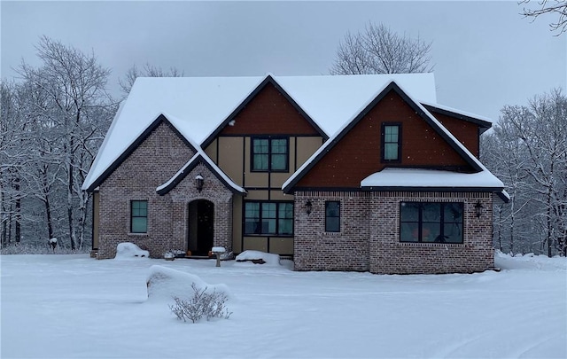 tudor-style house featuring brick siding