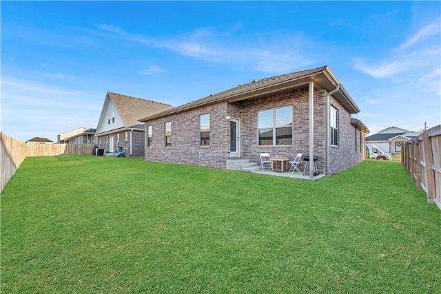 back of property featuring a lawn and a patio area