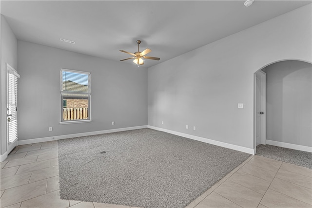 spare room featuring ceiling fan and light tile patterned flooring