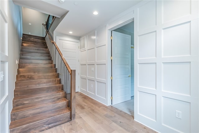 staircase with wood-type flooring