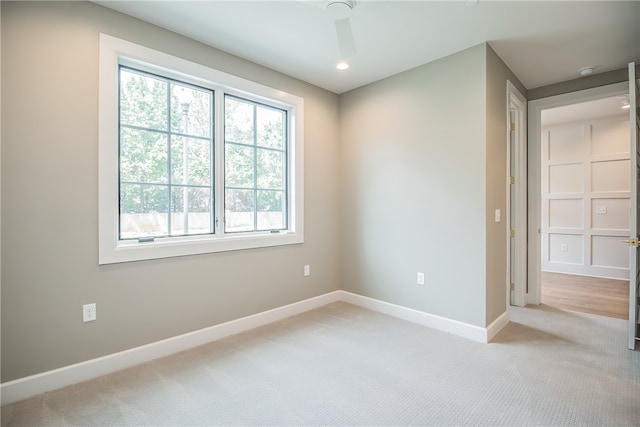 carpeted empty room featuring ceiling fan