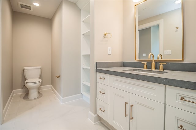 bathroom featuring vanity, toilet, and tile patterned floors