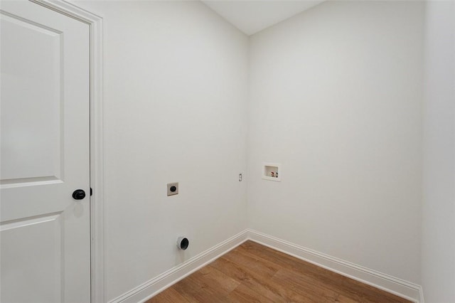 clothes washing area with hardwood / wood-style flooring, washer hookup, and hookup for an electric dryer