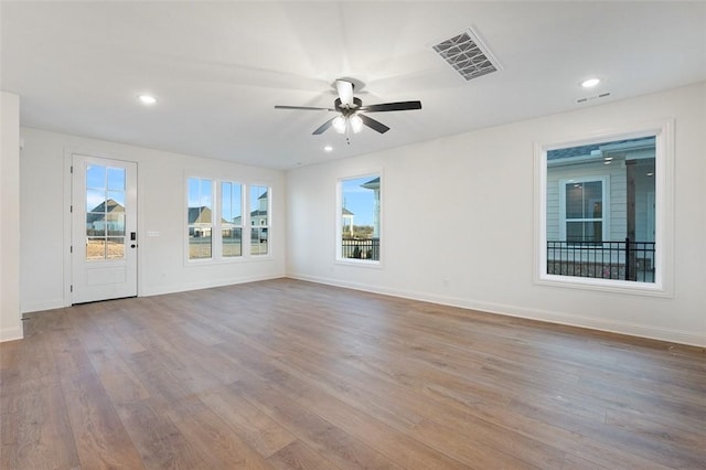 empty room featuring ceiling fan and light wood-type flooring