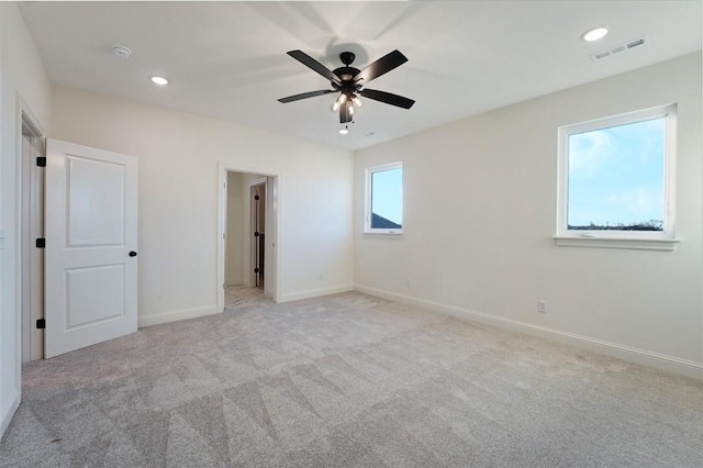 unfurnished bedroom with light carpet and ceiling fan