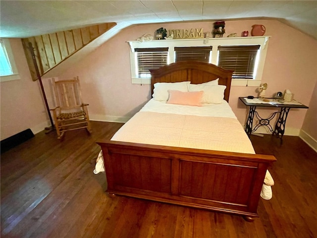 bedroom with lofted ceiling and dark wood-type flooring