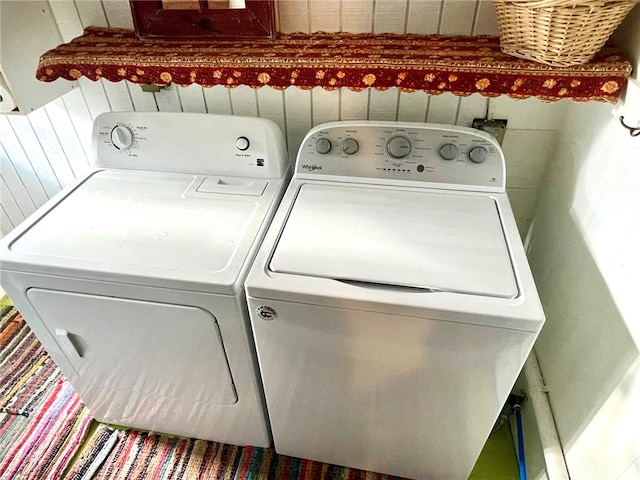 clothes washing area with washer and clothes dryer