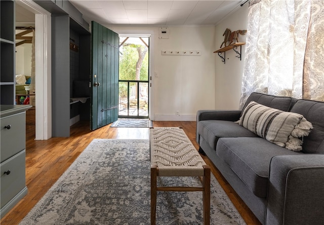 living room with crown molding and hardwood / wood-style floors