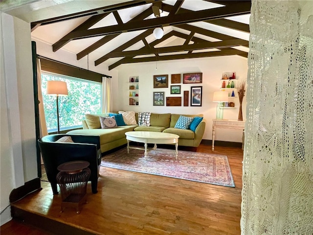 living room with wood-type flooring and vaulted ceiling with beams