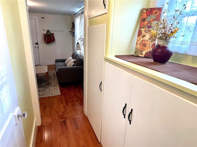 corridor with hardwood / wood-style floors