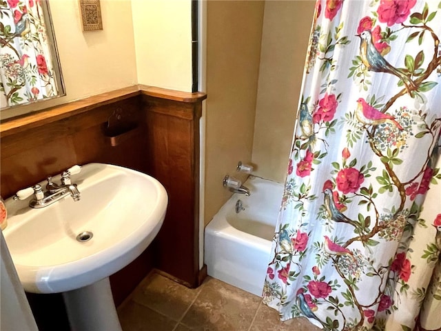 bathroom featuring tile patterned flooring, shower / bathtub combination with curtain, and sink