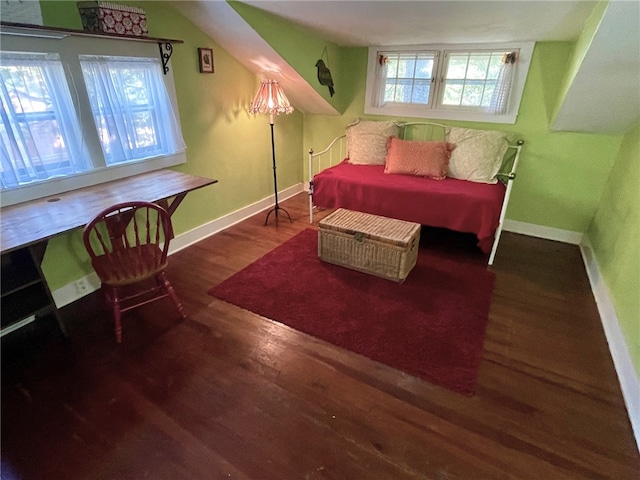 bedroom with dark hardwood / wood-style floors