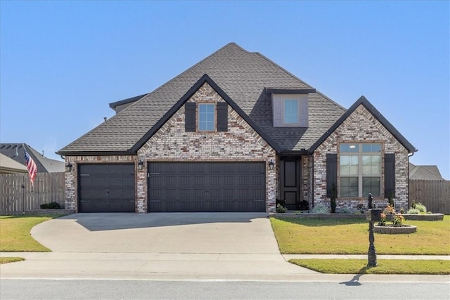 view of front of property with a garage and a front lawn