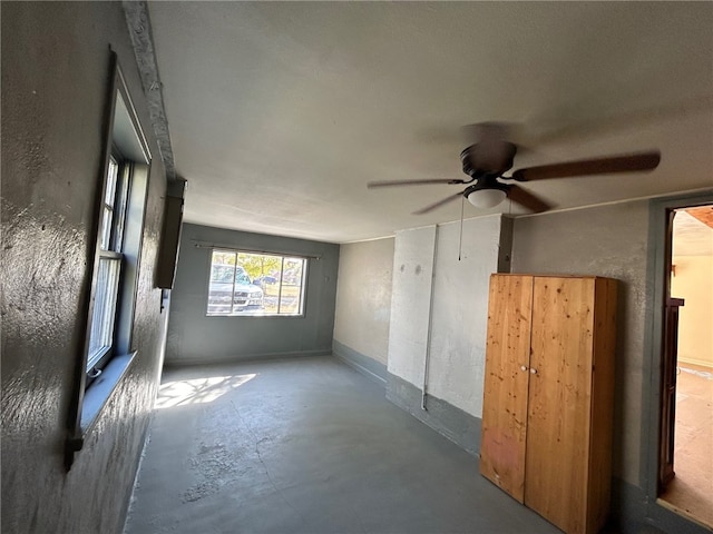 empty room featuring concrete flooring and ceiling fan