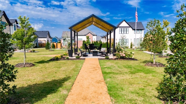 view of community with a patio, a yard, and a residential view