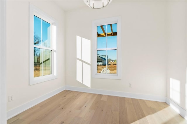 unfurnished dining area with light wood finished floors, baseboards, and a wealth of natural light