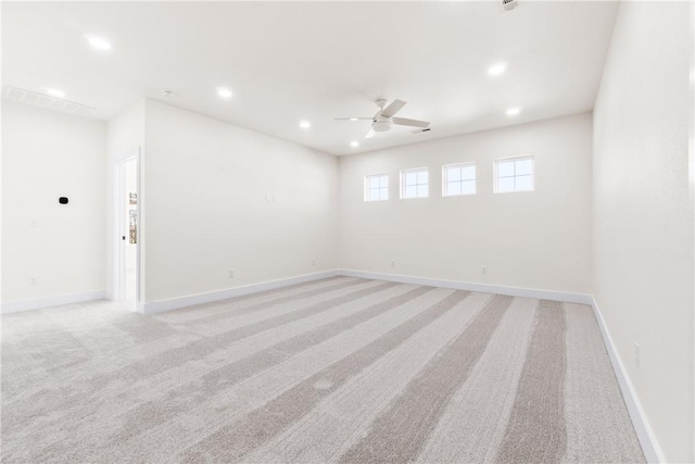 unfurnished room featuring light colored carpet, ceiling fan, baseboards, and recessed lighting