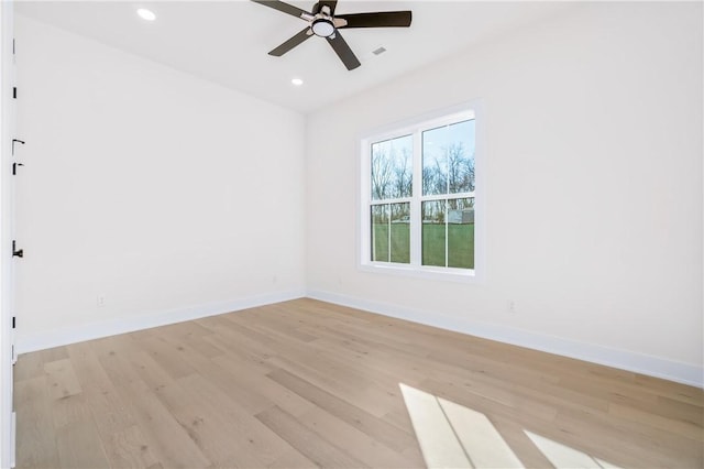 unfurnished room featuring recessed lighting, light wood-type flooring, and baseboards