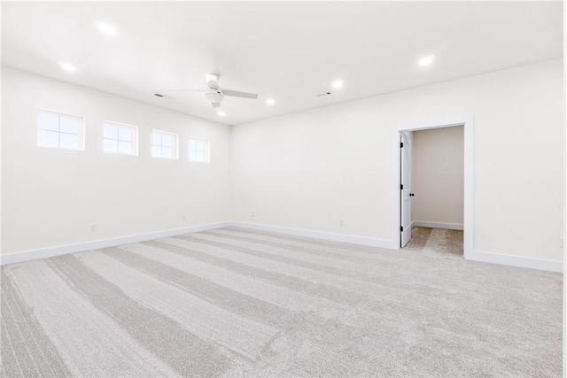 spare room featuring recessed lighting, baseboards, light colored carpet, and ceiling fan
